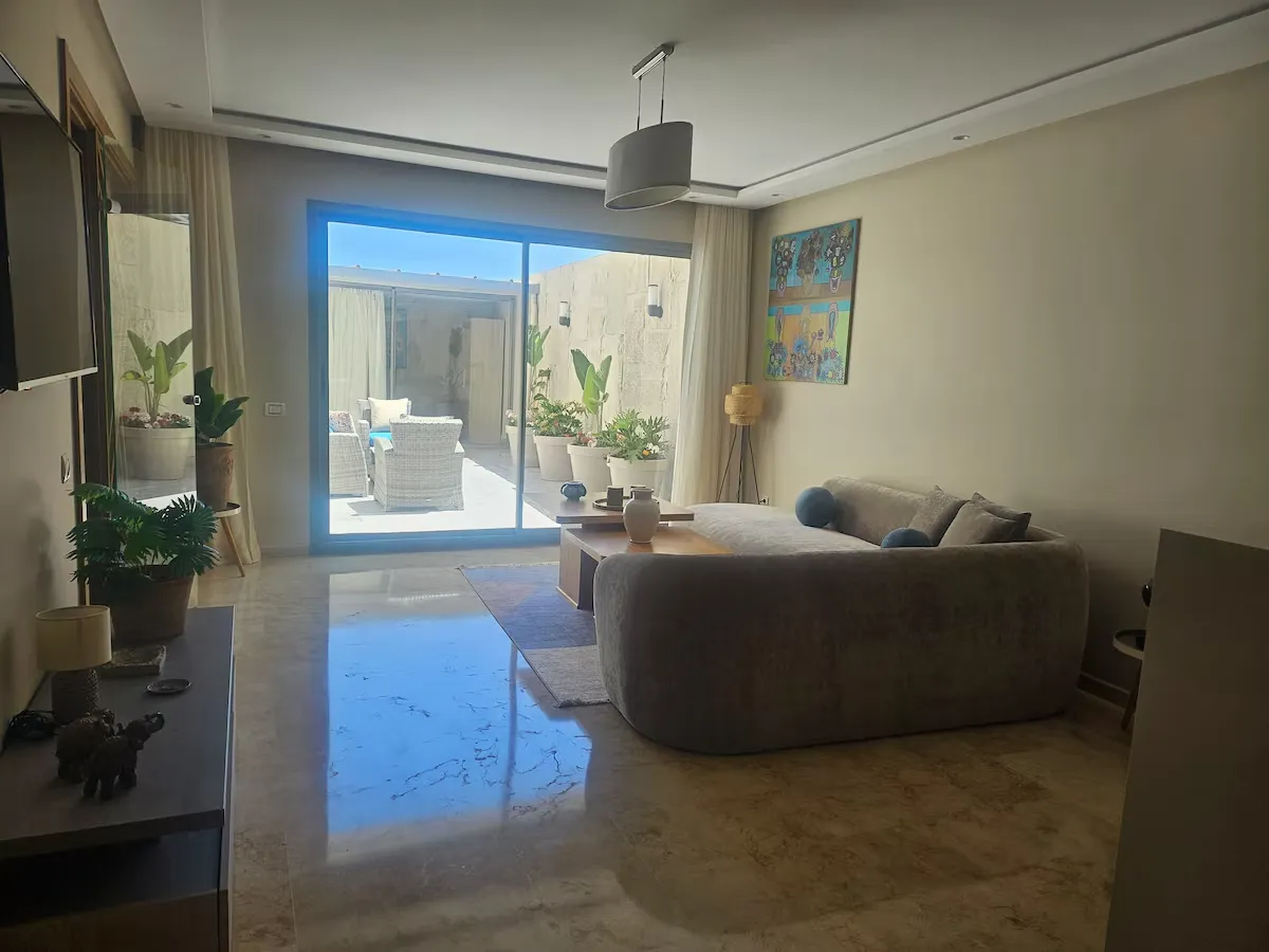 Open-plan studio apartment layout showing living area and terrace view at Ciel Studio