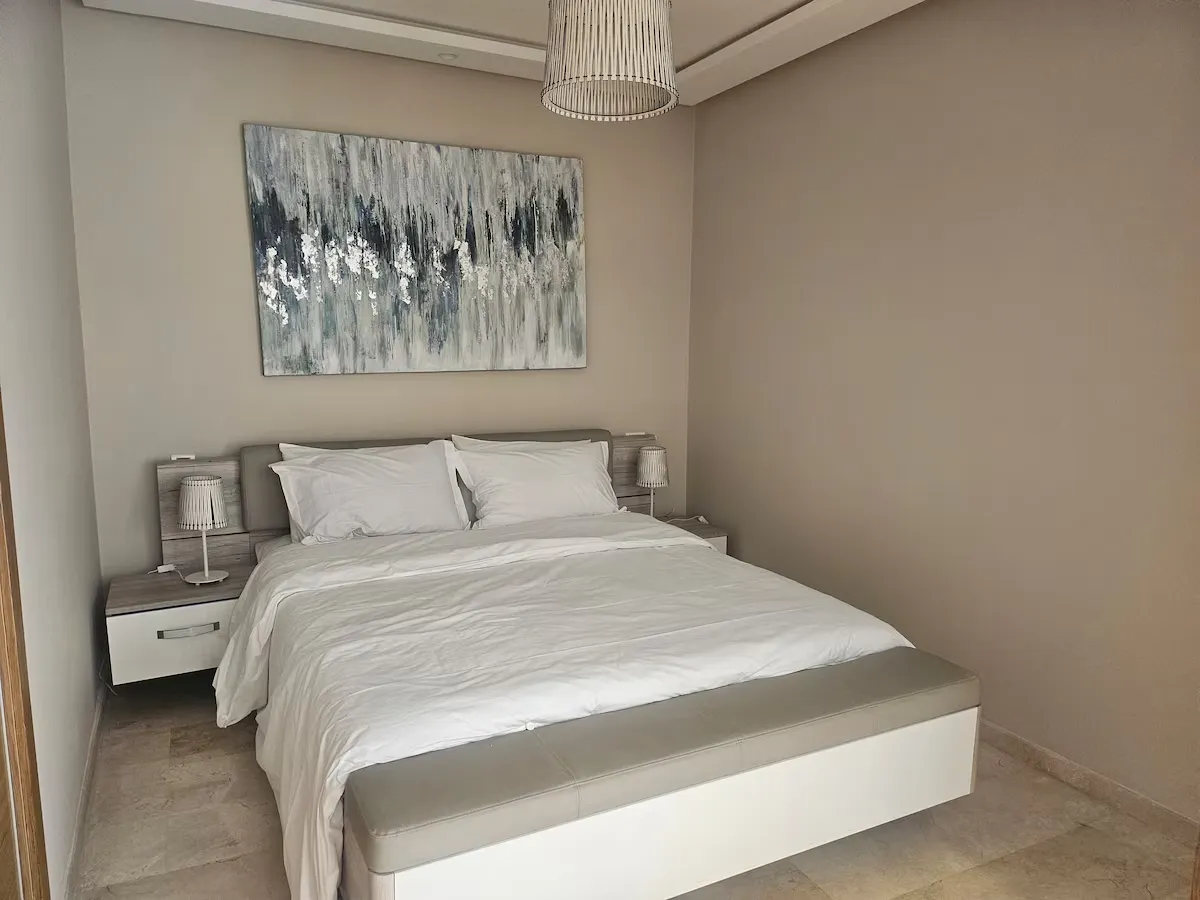 Modern bedroom suite in Ciel Studio Casablanca with neutral decor and artwork
