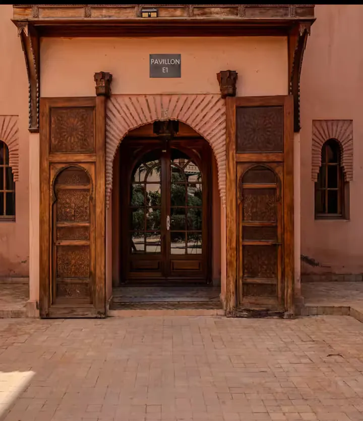 Artificial lake with water fountain and landscaped gardens surrounding an apartment with pool in Marrakech
