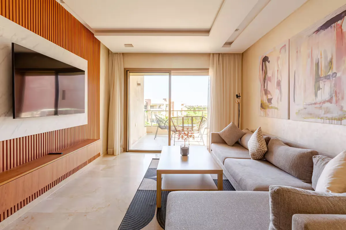 Private terrace with Acapulco lounge chairs overlooking the pool and golf course at a palm grove apartment