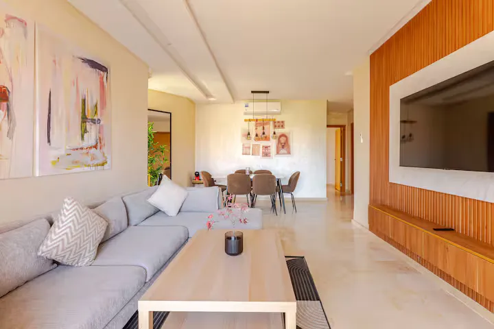 Overview of the spacious open-plan living and dining area in a renovated palm grove apartment