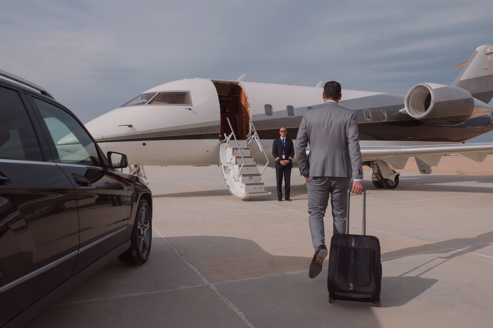 Man walking towards a private jet for boarding