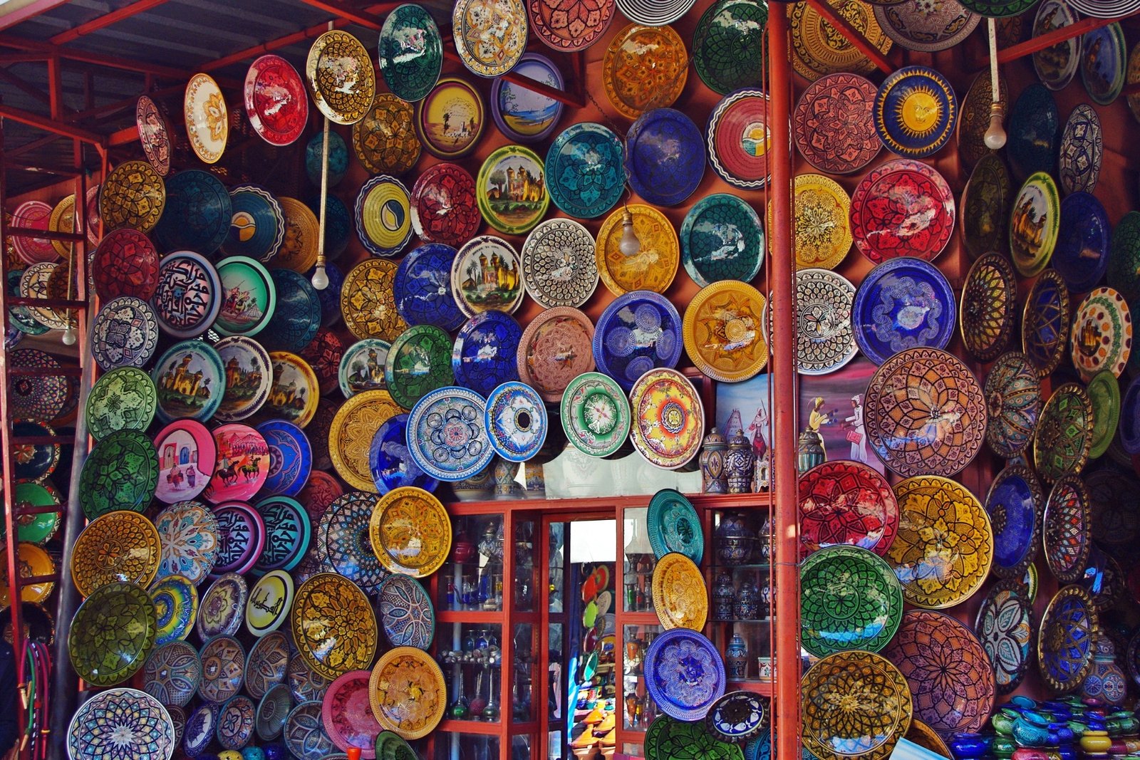 Colorful handmade Moroccan ceramic plates displayed in an artisan souk shop