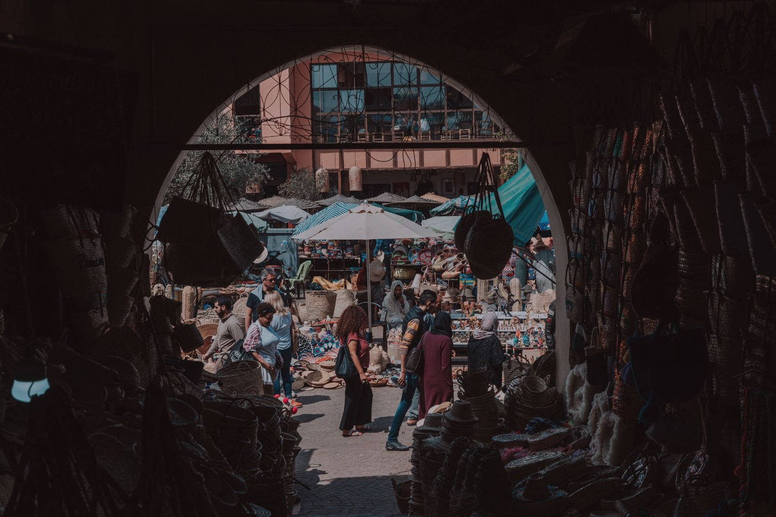Visitors explore the narrow souks of Marrakech Medina, surrounded by traditional crafts