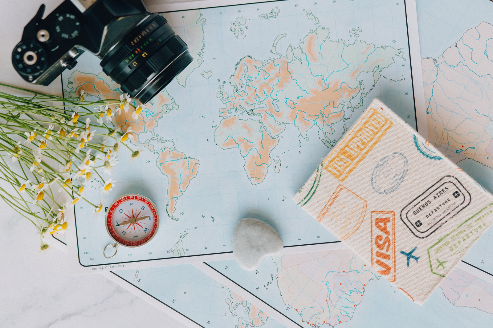 Travel map with camera, compass and notebook