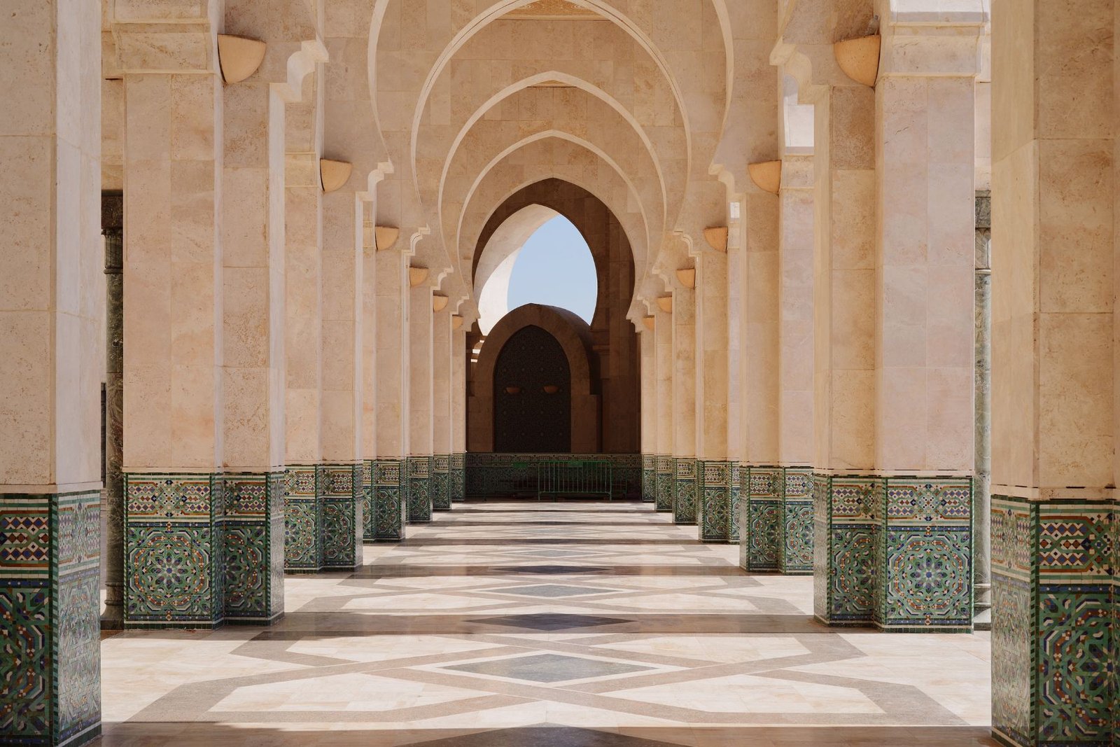 Intricate zellij tilework arches and columns inside the Hassan II Mosque in Casablanca