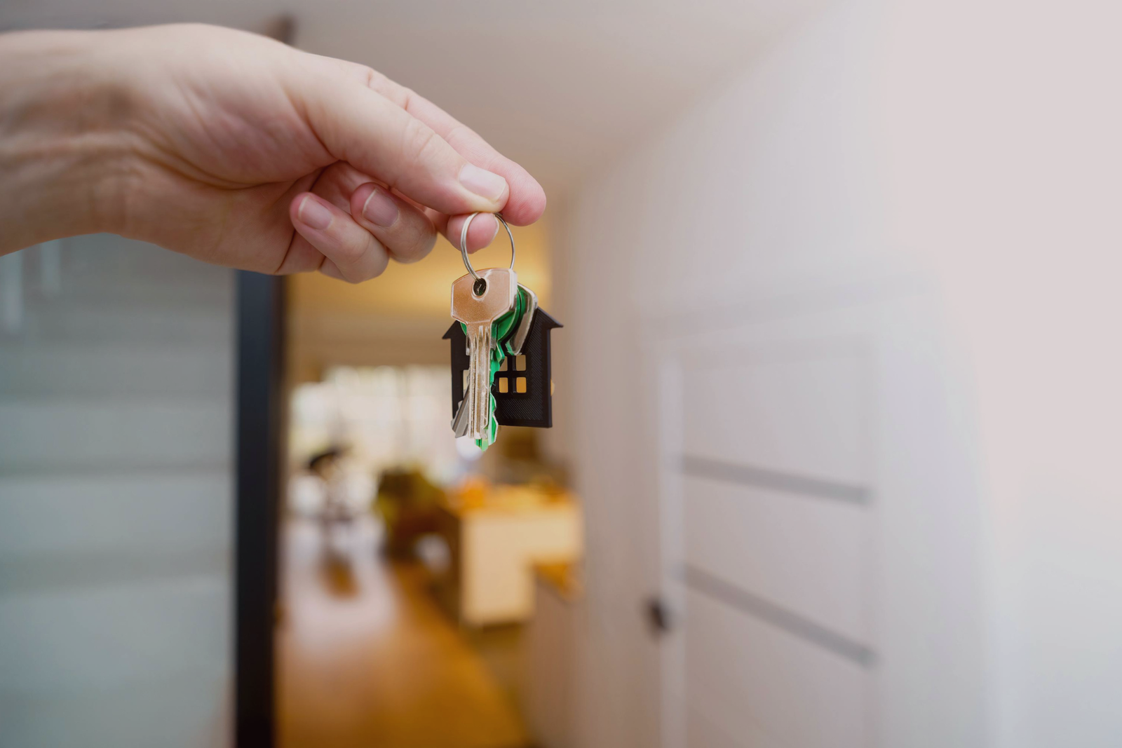 Hand holding keys to a private home