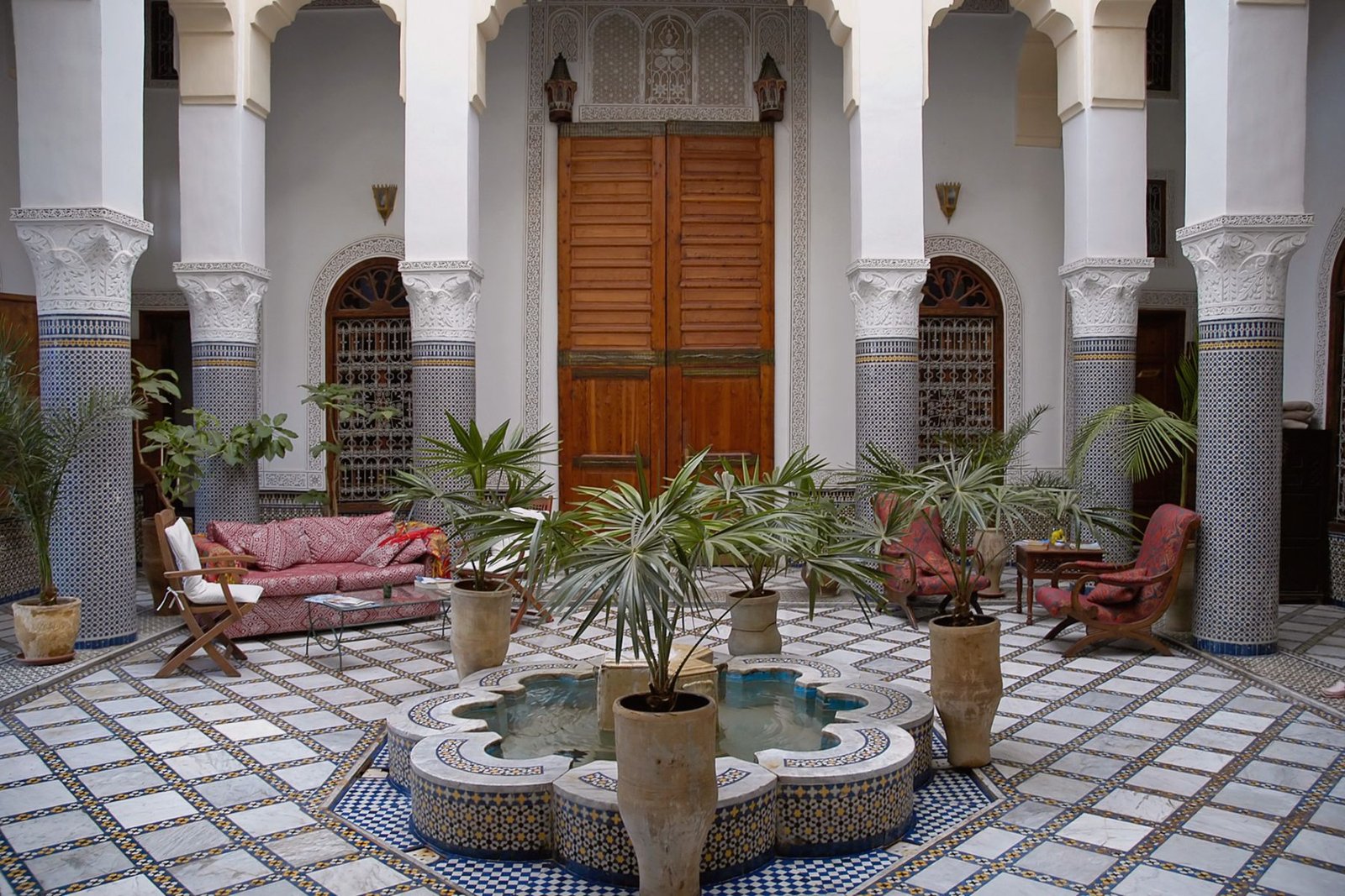 Traditional Moroccan Riad with a central marble fountain and zellige tiles in a luxury riad